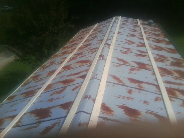 Rusted metal roof panels with new wood purlins before replacement — Storm Damage Roof Repair in Worton by Roofing Brothers